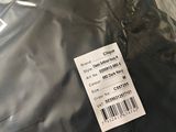 a label on the back of a jacket that is wrapped in plastic