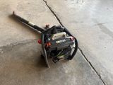a small blower sitting on the ground next to the sidewalk