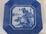 blue and white plate with a picture of a castle on it