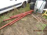 a lot of pipes and a car in the yard