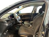 the interior of a car with the door open and the driver ' s seat down