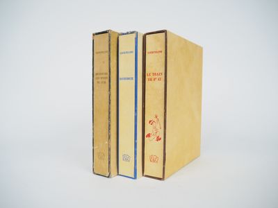 three books are stacked on top of each other on a white surface