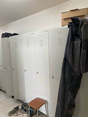 several lockers are lined up in a hallway with shoes on the floor