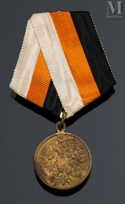 une image représentant une médaille entourée d'un ruban orange, blanc et noir