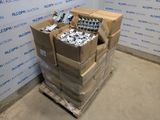 a stack of boxes of assorted items on a pallet in front of a wall