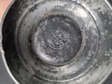 someone is holding a silver cup with a picture of a horse on it