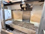 a machine that is cutting a piece of metal