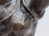a bronze statue of a woman holding a tennis racquet