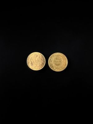 two gold coins on a black background