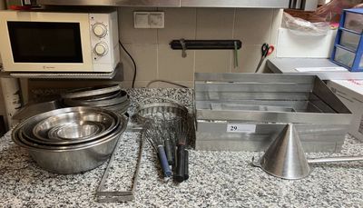 a lot of kitchen utensils that are on the counter