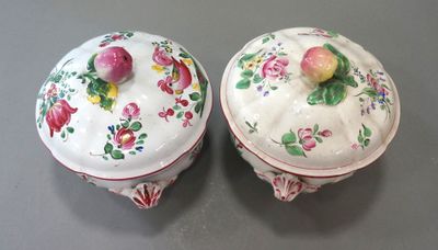 two white dishes with pink flowers on them on a table