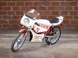 a motorcycle that is parked in front of a brick wall