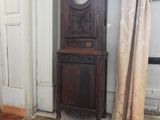 a grandfather clock in the corner of a room
