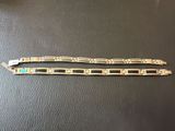 a pair of silver bracelets with turquoise stones on them