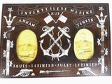 carvings of a man and a woman on a plaque with the names of them