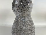 a gray vase with an owl on it