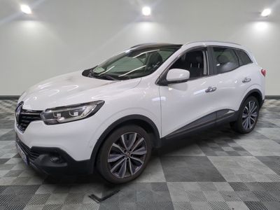 the white car is parked on a checkered tile floor