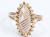 a close up of a gold ring with a diamond on it