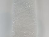 a roll of white tissue sitting on top of a white table