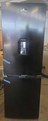 a black refrigerator in the middle of a room that is being remodeled