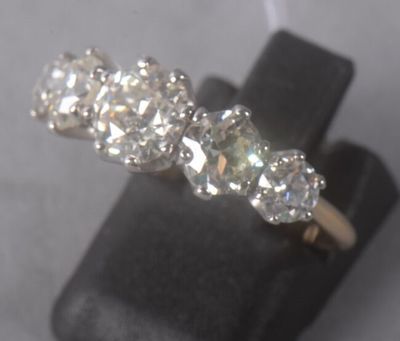 an image of a three stone diamond ring sitting on top of a black ring holder