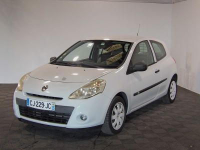 a picture of a small white car parked in a garage