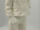 a white statue of a man with a hat on