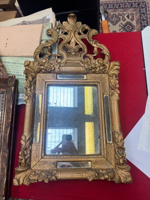 a mirror sitting on a table next to a mirror