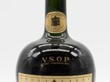 an old bottle of courvoisir is sitting on a white surface