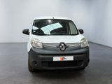the small white van is parked in a room with a black floor