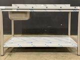 a stainless steel table with a sink under it