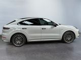 a white porsche cayen is parked in a white room