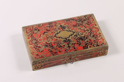 an old red and gold box with a floral design on it