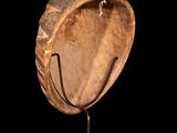 a close up of a wooden object on a stand