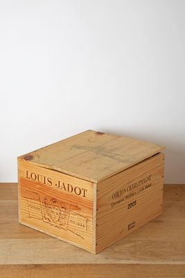 wooden box on a wooden table with a white wall in the background