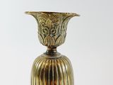 a gold vase that is sitting on a table
