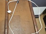 a brown suitcase with a white cord on top of it