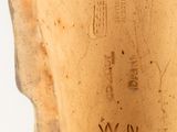 a close up of a vase on a white surface