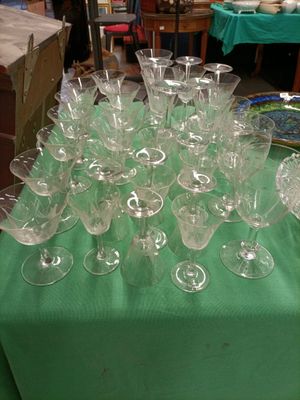 many empty wine glasses sitting on a green table