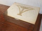 a wooden box with a design on it on a table