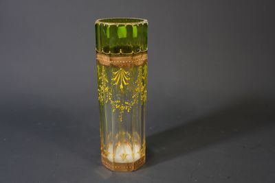 a green glass vase with a gold decoration on it