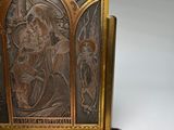 a metal plaque with a picture of a man and a woman on it