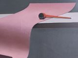 a picture of a pink paper bird with a black eye
