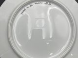 a white plate with a picture of a dog on it