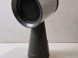 a black and silver speaker on a stand on a table