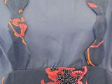 an image of a woman wearing a dress with red flowers on it