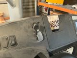 a close up of a car dashboard with a number plate on it
