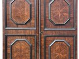 pair of antique wooden doors with carved panels on each side
