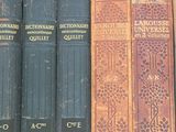 several old books are in a box on a table