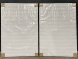 two pieces of white marble sitting on a table